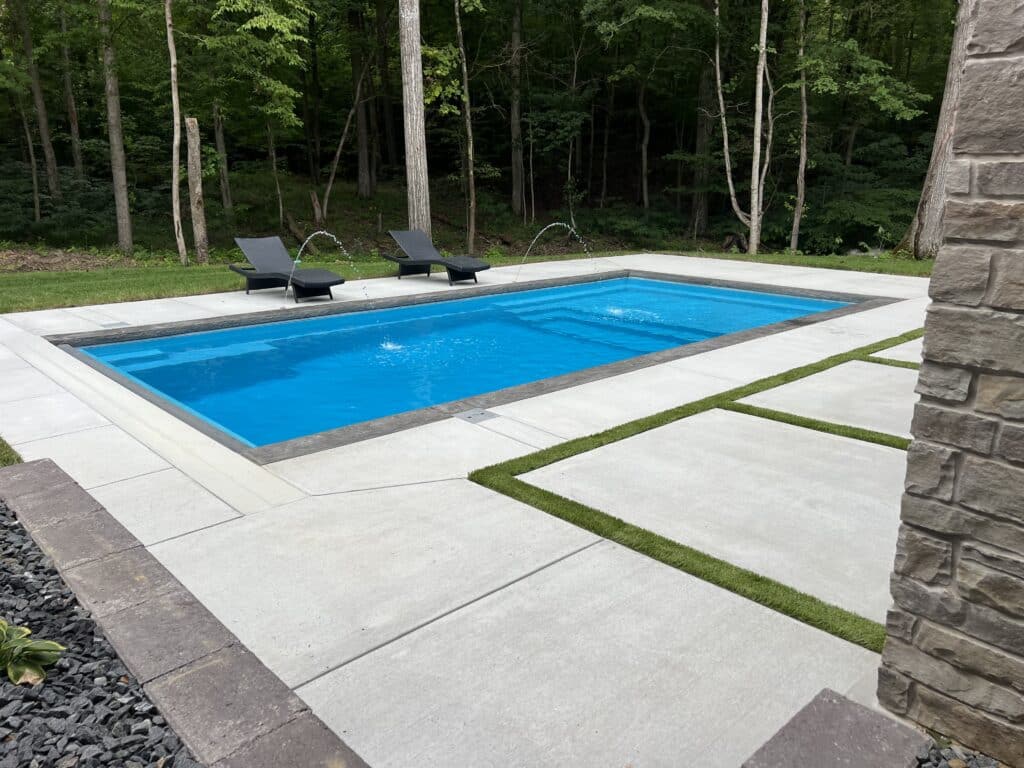 Image of a fiberglass pool installed by pool companies in Borden, Indiana with a decorative concrete patio