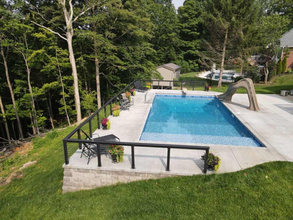 Image of pool construction Borden IN featuring a custom fiberglass pool and outdoor living space